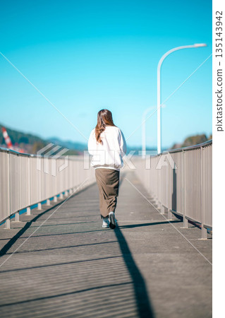 年輕女子在海邊散步 年輕女子在海邊散步 135143942