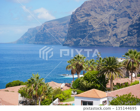 Ocean Cliffs and Terracotta Roofs in Tropical Coastal Town, Spain, Tenerife, Los Gigantes Ocean Cliffs and Terracotta Roofs in Tropical Coastal Town, Spain, Tenerife, Los Gigantes 135144695