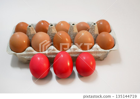 Red Dyed Easter Eggs and Natural Eggs in Carton 135144719
