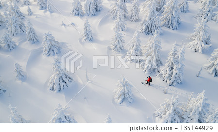Beautiful Winter Mountain Scenery with Man on Cross-Country Skis , Aerial View Beautiful Winter Mountain Scenery with Man on Cross-Country Skis , Aerial View 135144929