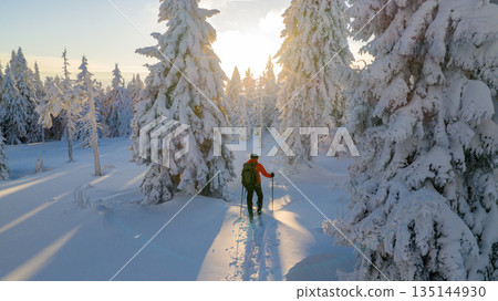 Beautiful Winter Mountain Scenery with Man on Cross-Country Skis , Aerial View Beautiful Winter Mountain Scenery with Man on Cross-Country Skis , Aerial View 135144930