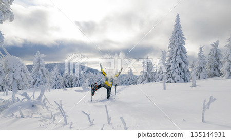 Beautiful Winter Mountain Scenery with Man on Snowshoes , Aerial Beautiful Winter Mountain Scenery with Man on Snowshoes , Aerial 135144931