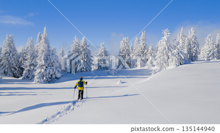 Beautiful Winter Mountain Scenery with Man on Snowshoes , Aerial Beautiful Winter Mountain Scenery with Man on Snowshoes , Aerial 135144940