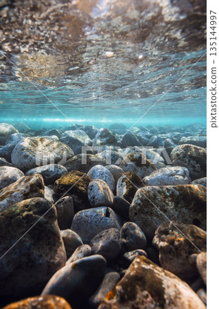 Underwater landscape with stones sea bottom and sun rays in water. Underwater landscape with stones sea bottom and sun rays in water. 135144997