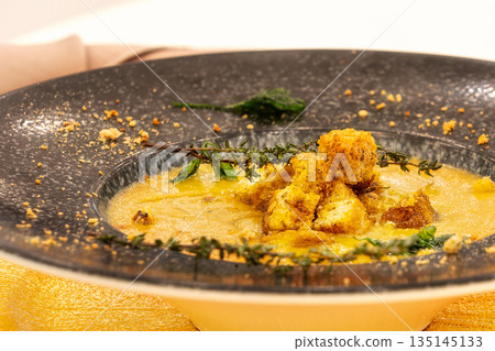 Sweet potato soup with croutons and thyme leaves. toning. selective focus Sweet potato soup with croutons and thyme leaves. toning. selective focus 135145133