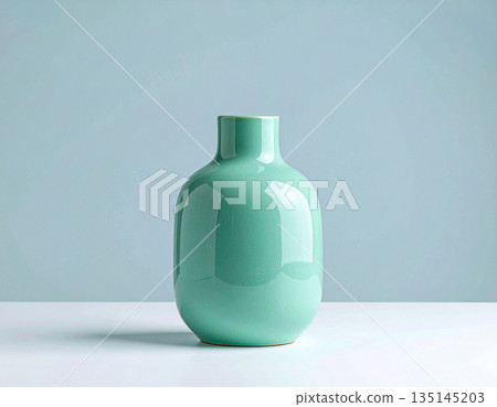 Home lifestyle appeal. Ceramic vase in green tones on a white background. Modern minimalist vase. Neutral tones. 135145203