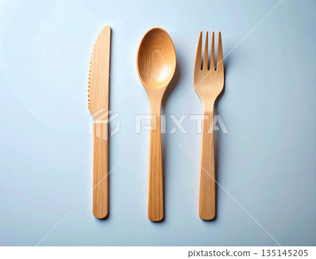 Zero waste. Set of eco-friendly bamboo cutlery: wooden spoon, fork and knife on a white background. Zero waste. Set of eco-friendly bamboo cutlery: wooden spoon, fork and knife on a white background. 135145205