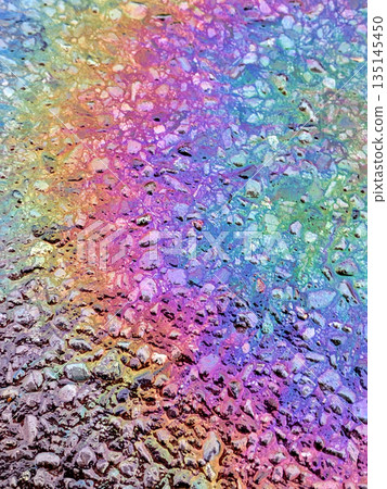 Oil Petrol Rainbow Leak Running over the road tarmac 135145450