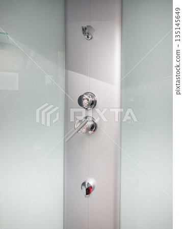 Modern shower control panel with sleek design and polished finish 135145649