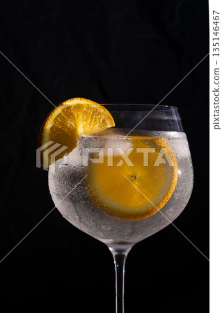 Gin and tonic drink with orange and ice 135146467