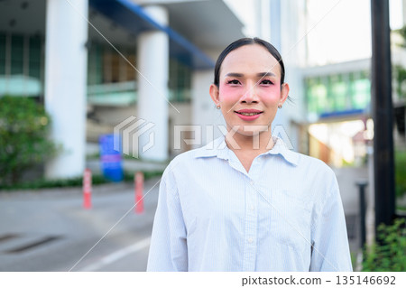 Portrait of a young Thai transgender business person in city looking at camera Portrait of a young Thai transgender business person in city looking at camera 135146692