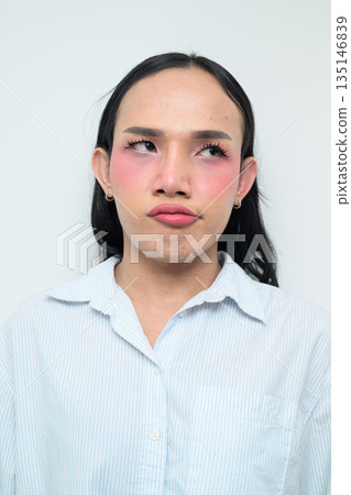 Portrait of a young bored Thai transgender business person against white background Portrait of a young bored Thai transgender business person against white background 135146839