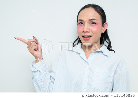 Portrait of a young Thai transgender person pointing finger against white background Portrait of a young Thai transgender person pointing finger against white background 135146856
