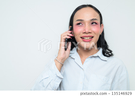 Portrait of a young Thai transgender person on the phone against white background 135146929