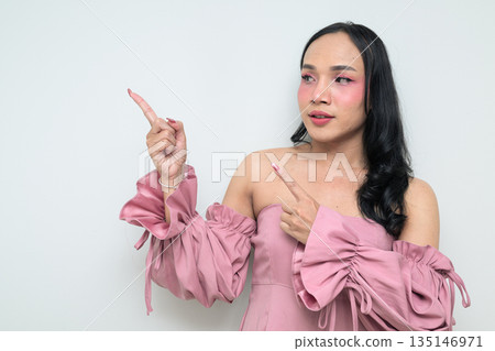 Portrait of a young Thai transgender person against white background pointing finger 135146971