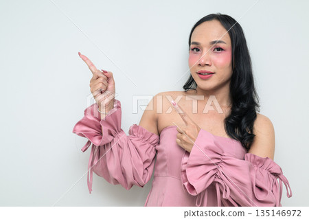 Portrait of a young Thai transgender person against white background pointing finger 135146972
