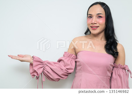 Portrait of young Thai transgender person against white background presenting and showing something Portrait of young Thai transgender person against white background presenting and showing something 135146982