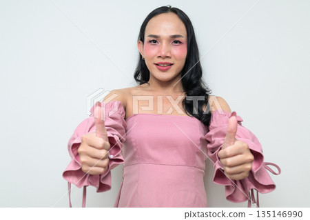 Portrait of a young Thai transgender person against white background with thumbs up gesture 135146990
