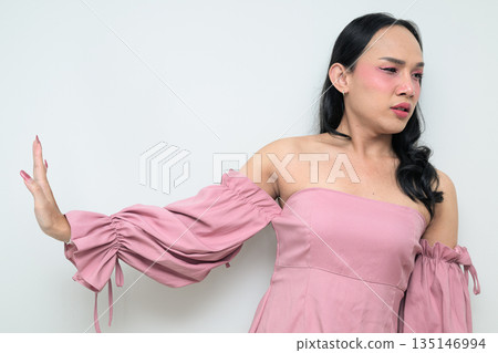 Portrait of a young Thai transgender person against white background with STOP hand gesture Portrait of a young Thai transgender person against white background with STOP hand gesture 135146994