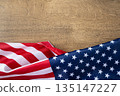 United States flag on wooden background with copy space, suitable for patriotic posters, banners, and national celebration designs. 135147227