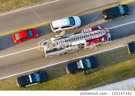 Car crash with first responders helping at accident site on American street. Vehicle collision on road in USA 135147342