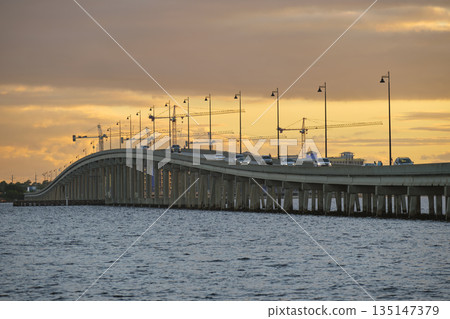Barron Collier Bridge and Gilchrist Bridge in Florida with moving traffic. Transportation infrastructure in Charlotte County connecting Punta Gorda and Port Charlotte over Peace River Barron Collier Bridge and Gilchrist Bridge in Florida with moving traffic. Transportation infrastructure in Charlotte County connecting Punta Gorda and Port Charlotte over Peace River 135147379
