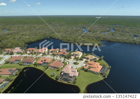 Aftermath of natural disaster. Surrounded by hurricane Ian rainfall flood waters homes in Florida residential area 135147422