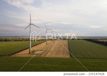 Aerial view of wind turbine generators in field producing clean ecological electricity. 135147426