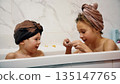 Two children playing with bath foam together at home during evening routine 135147765