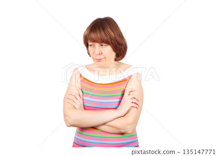 A frustrated young woman folded her arms across her chest A frustrated young woman folded her arms across her chest 135147771