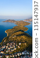 Aerial view of Kas peninsula with green hills, coastline and blue Mediterranean sea. Coastal town, islands, yachts and scenic landscape in Kas, Turkey. 135147937