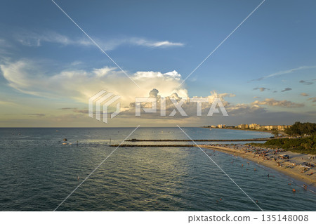 Aerial view of Nokomis beach in Sarasota County, USA. Many people enjoing vacation time swimming in gulf water and relaxing on warm Florida sun at sunset Aerial view of Nokomis beach in Sarasota County, USA. Many people enjoing vacation time swimming in gulf water and relaxing on warm Florida sun at sunset 135148008