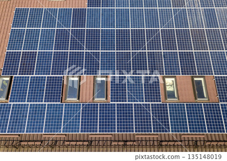 Aerial view of many solar panels mounted of industrial building roof. 135148019