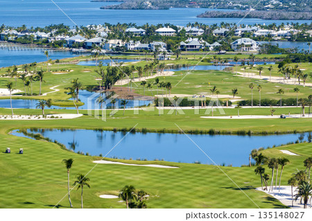 Aerial view of large golf field with green grass in Boca Grande, small town on Gasparilla Island in southwest Florida. Outdoor activities for wealthy people Aerial view of large golf field with green grass in Boca Grande, small town on Gasparilla Island in southwest Florida. Outdoor activities for wealthy people 135148027