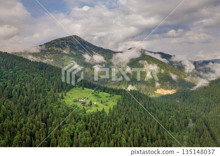 Aerial view of green Carpathian mountains covered with evergreen spruce pine foreston summer sunny day. Aerial view of green Carpathian mountains covered with evergreen spruce pine foreston summer sunny day. 135148037