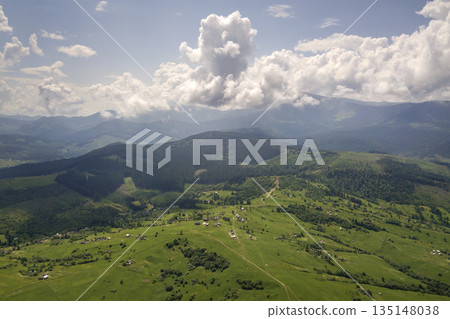 Aerial view of green Carpathian mountains covered with evergreen spruce pine foreston summer sunny day. Aerial view of green Carpathian mountains covered with evergreen spruce pine foreston summer sunny day. 135148038