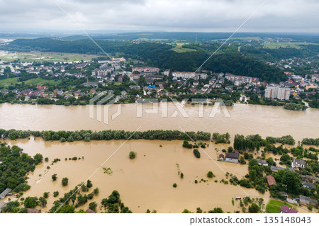 Aerial view of flooded houses with dirty water of Dnister river in Halych town, western Ukraine. Aerial view of flooded houses with dirty water of Dnister river in Halych town, western Ukraine. 135148043