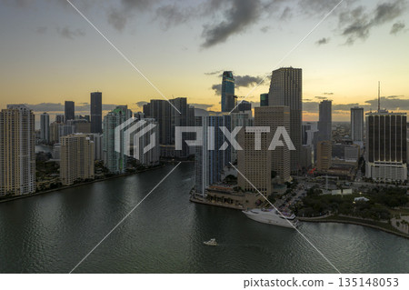 Aerial view of downtown district of of Miami Brickell in Florida, USA at sunset. High commercial and residential skyscraper buildings in modern american megapolis Aerial view of downtown district of of Miami Brickell in Florida, USA at sunset. High commercial and residential skyscraper buildings in modern american megapolis 135148053