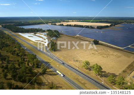 Aerial view of big sustainable electric power plant with many rows of solar photovoltaic panels for producing clean electrical energy. Renewable electricity with zero emission concept Aerial view of big sustainable electric power plant with many rows of solar photovoltaic panels for producing clean electrical energy. Renewable electricity with zero emission concept 135148125