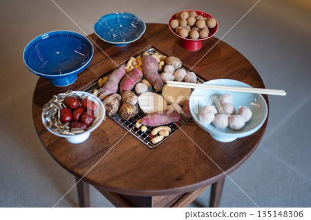 Colorful Traditional Sweets And Fruits Displayed Artfully On Charcoal Grill Round Table 135148306