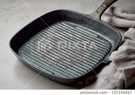 empty grill pan and linen towel empty grill pan and linen towel 135149887