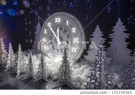 Holiday scene with glowing clock, Magical midnight countdown with shimmering decorations, Enchanting holiday setting featuring luminous clock and sparkling ornaments 135150563