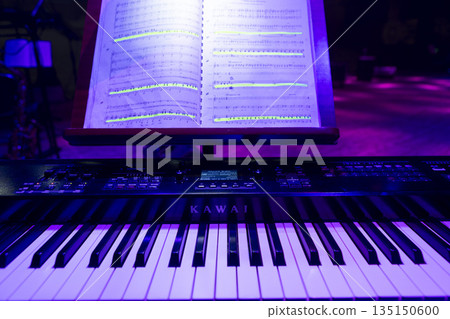A keyboard instrument with notes on stage before a concert A keyboard instrument with notes on stage before a concert 135150600