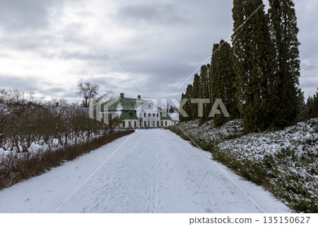 A walk through a snowy winter park on the way to the building 135150627