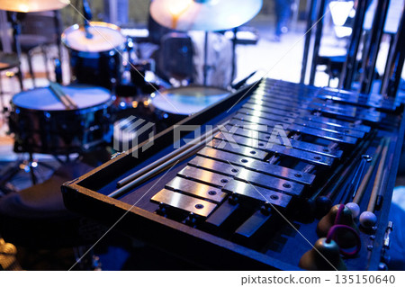 Percussion instruments, metallophone, xylophone are set up on the stage of the concert hall Percussion instruments, metallophone, xylophone are set up on the stage of the concert hall 135150640