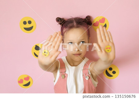 The person shows palms with stickers of various smiley faces. A set of emoji icons for use in social media messaging. World Smiley Day 135150676