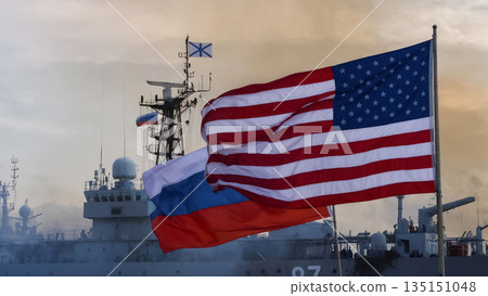 flags of the usa and russia against a warship in the haze 135151048