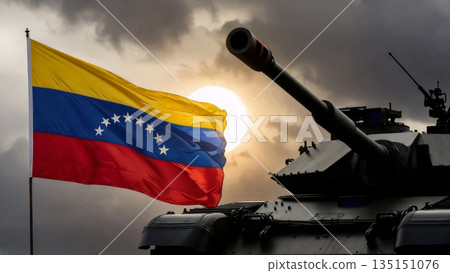 venezuelan flag and silhouette of a military tank against a bright setting sun and dark storm clouds 135151076