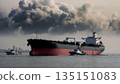 large oil tanker in the open sea with tugboats 135151083