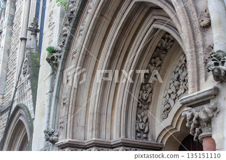 Oxford, United Kingdom - Dec 22, 2025: Wesley Memorial Church, a Methodist church in central Oxford. Tympanum above the entrance, decorated with stone carvings. Oxford, United Kingdom - Dec 22, 2025: Wesley Memorial Church, a Methodist church in central Oxford. Tympanum above the entrance, decorated with stone carvings. 135151110